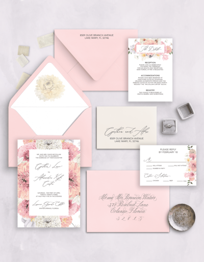 Flat lay of a blush pink wedding invitation suite