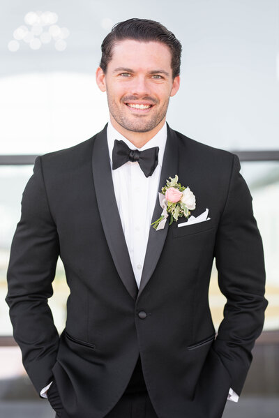 Groom smiles in tuxedo on his wedding day