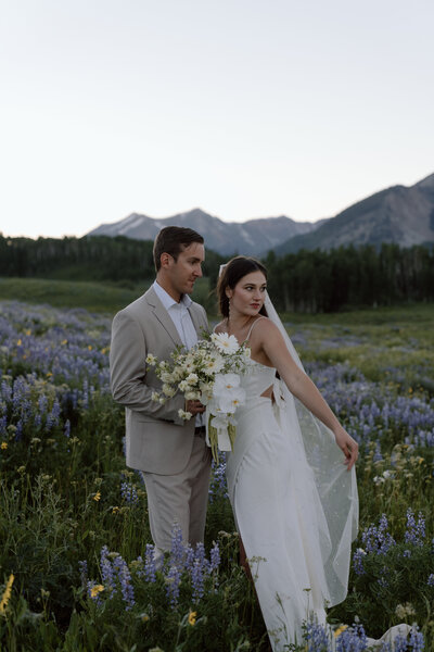 Bride and groom in crested butte wildflower field