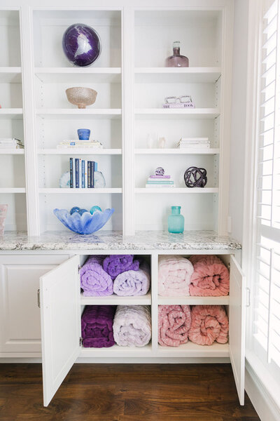 Soft Minky Couture Hugs blankets organized in white cabinets