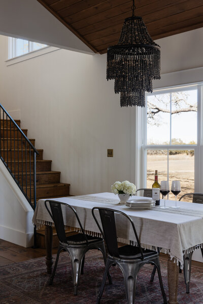 A simple tablescape with a statement chandelier by Jessa Myer Interiors.
