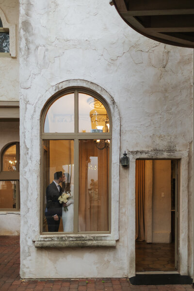 Cowboy hat with wedding rings and veil on saddle