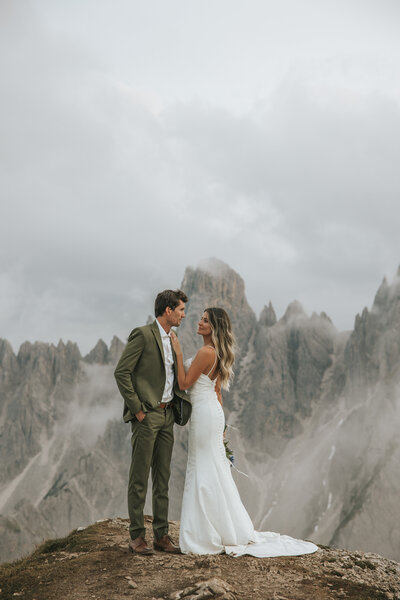 Bride and groom in a breathtaking embrace on their wedding day in the Dolomites.