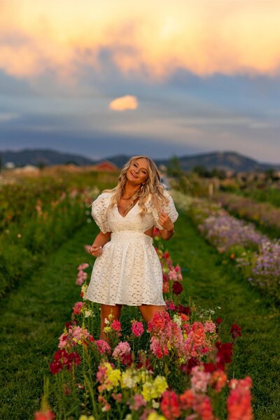 Olivia poses in a flower field for her senior photos.