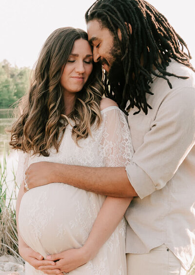 married couple embracing during a maternity session in raleigh nc