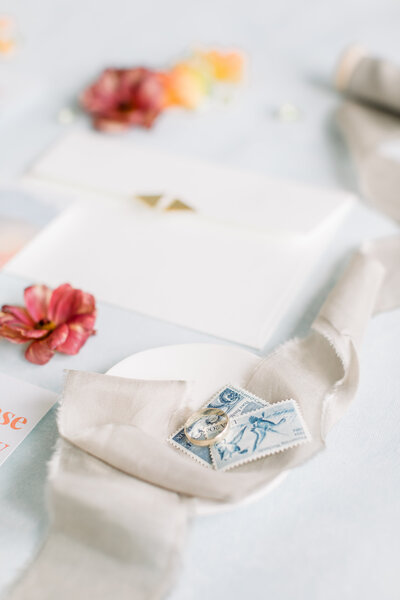 Gray ribbon, blue stamps, and a gold heirloom ring
