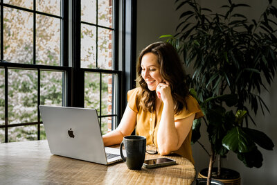 Melonie smiling on a video meeting, ready to connect with clients to discuss their health and wellness web design needs.