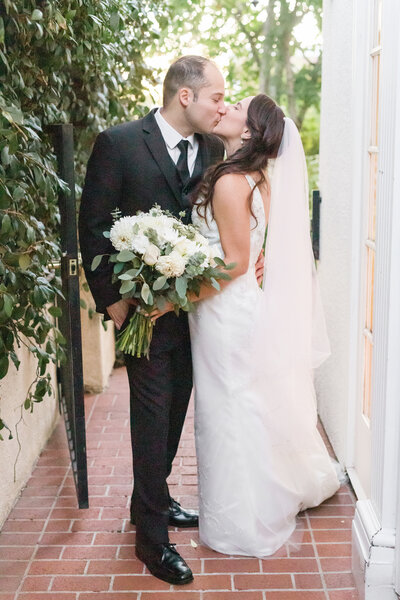 a bride and groom share a kiss at their vizcaya sacramento wedding.