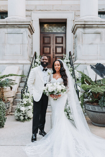 bride and groom pose for portraits at historic dekalb courthouse