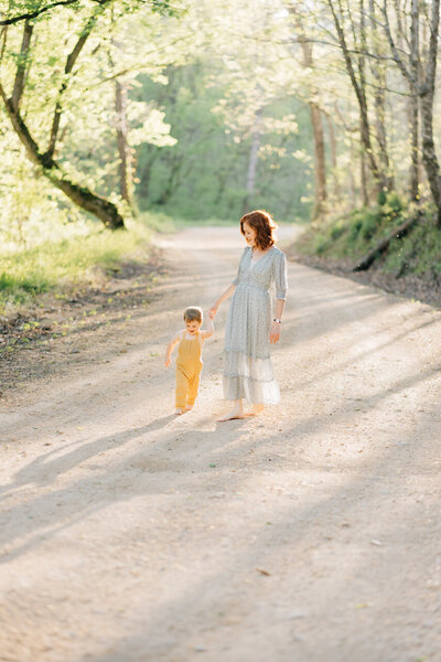 Mother and son walking down a dirt road