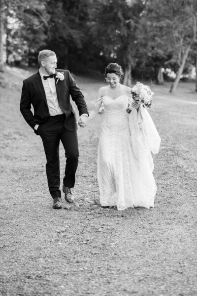 A Ohio groom and a bride happily embrace one another during their golden hour couples portraits on their wedding day at The Ponds Venue.  Photographed by Aaron Aldhizer