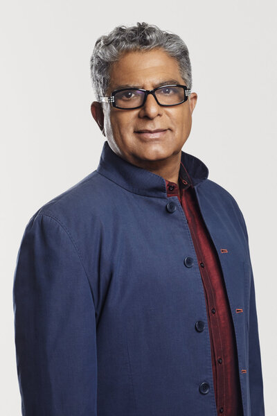 Professional portrait of Deepak Kim in a smart blue jacket, photographed by Ylva Erevall.