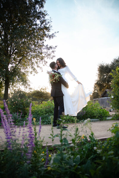 a wedding couple in a candid shot at sunset