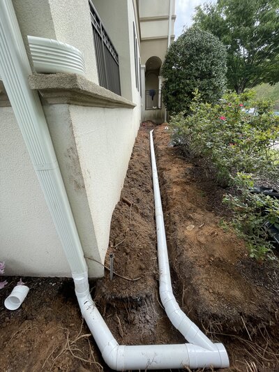 Installed downspout extension system by APS Waterproofing in Atlanta to redirect water away from the foundation.