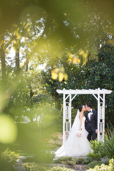 Couple kissing at their wedding at La River Center and Gardens