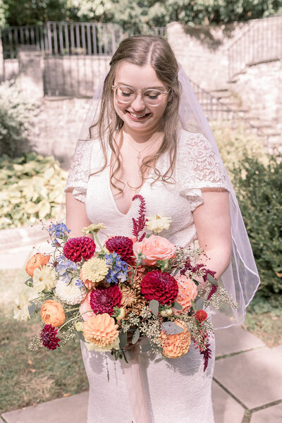 Detroit Michigan bride smiling with her bouquet in her arms