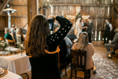 Lori Mortensen laughing in a greenhouse. Lori is a Des Moines Iowa wedding and family photographer.