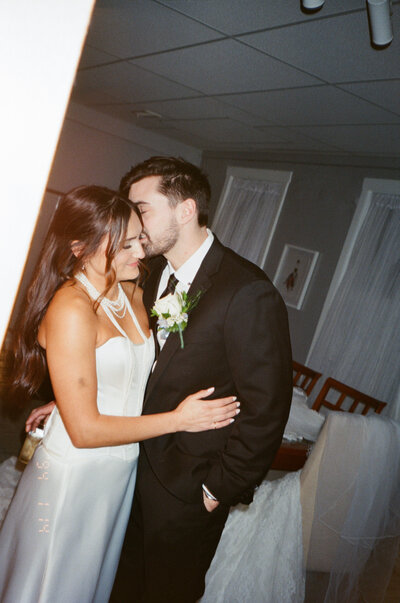 film bar engagement photoshoot for engaged couple. Cheers with champagne toast in green lady lounge in kansas city