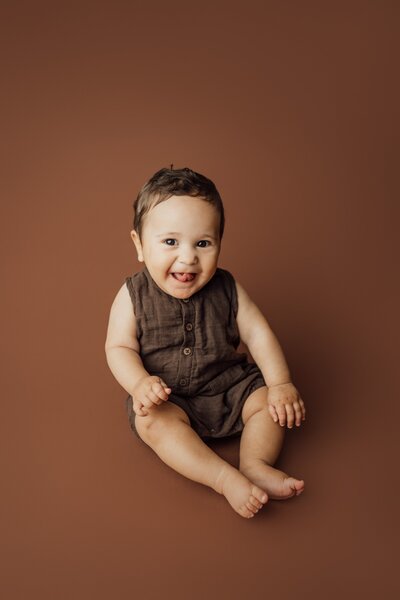 6 month boy poses on brown at studio in st. pete