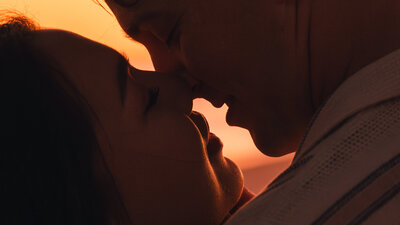 Cinematic engagement session on the north shore of oahu couple kissing