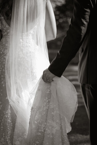 wedding gown groom holding train