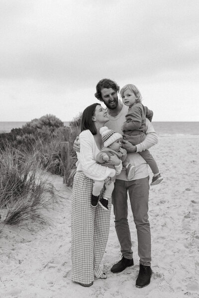 Image of Kyra, her hisband and two kids on a beach