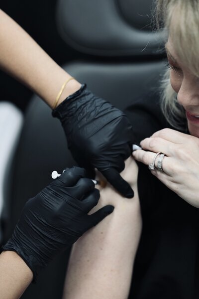 woman getting B 12 shot in arm