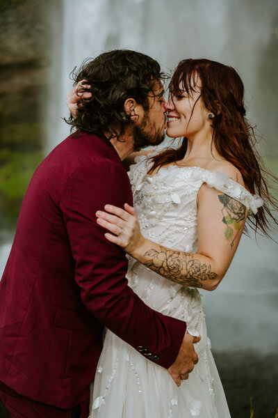 Couple kissing in front of the Seljalandfoss in Iceland during their elopement