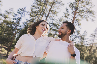 couple embraces under the trees for las vegas engagement session
