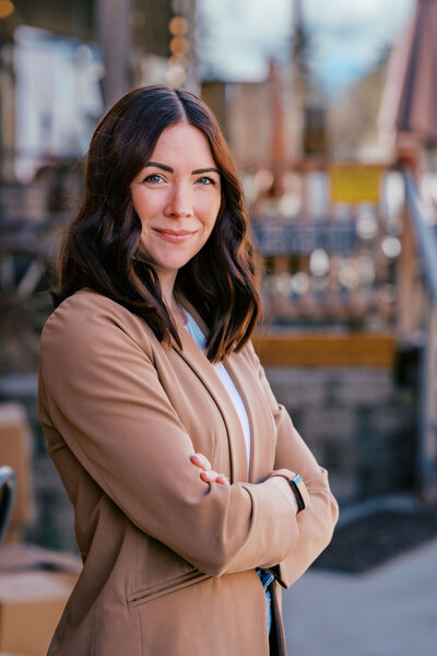 Confident woman in a tan blazer posing for a professional branding headshot outdoors, captured by Joseph Mayden for use in marketing, websites, and business profiles.