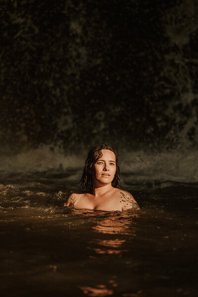 Event photographer takes photo of topless woman in water in nature on Sunshine Coast