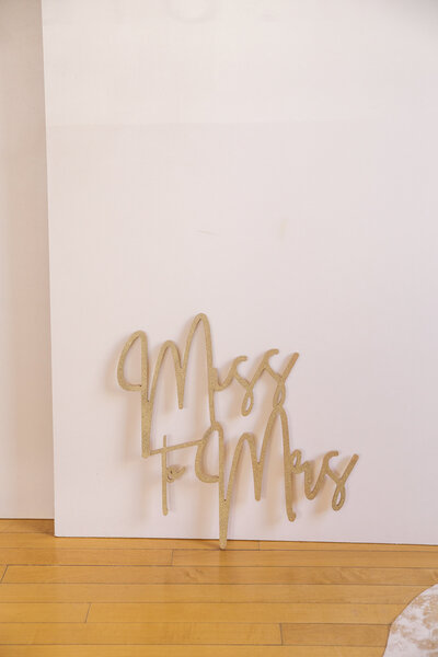 A gold sign that says Miss to Mrs.