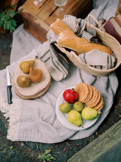 Fruit and bread sit on plates.