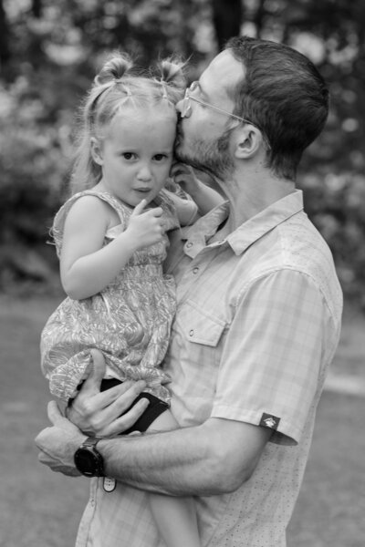 Dad kissing side of daughter's head | Family