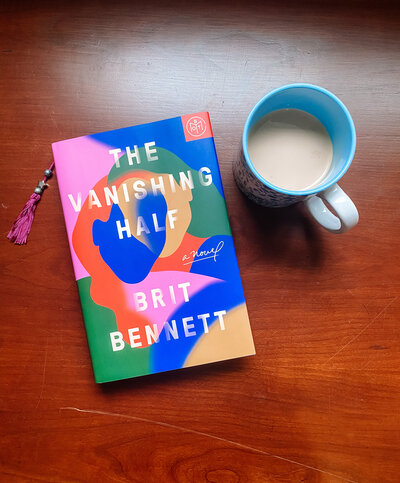 The Vanishing Half book laying on a table with a cup of coffee