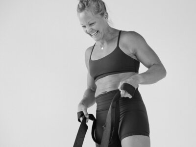 Lululemon brand ambassador, a strength athlete, laughing during a photoshoot, capturing confidence and positivity in fitness.