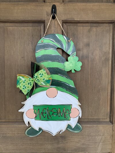 Green St. Patrick's Day gnome holding welcome sign