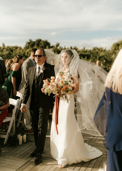 Bianca's Dad walks her down the aisle.