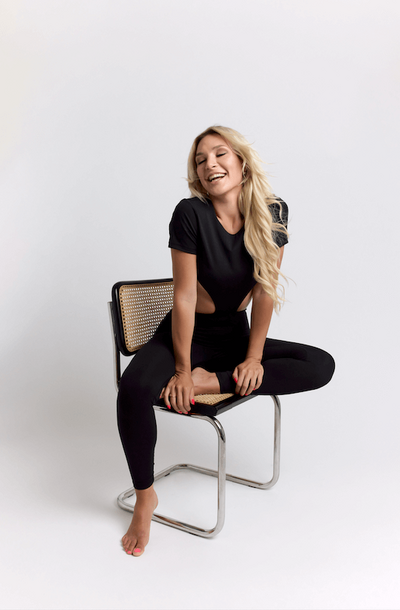 woman sitting on a chair on a cyc wall for a fashion clothing photoshoot lookbook