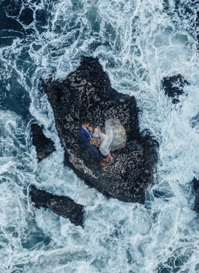 Photo of elopement couple kiss in on a rock in the ocean, Photo taken by kollar photography. Arizona Elopement Photographer