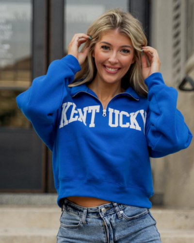 Model wearing blue cropped kentucky half zip pullover
