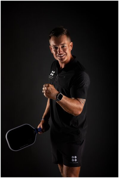 Athletic young man in Holbrook workout attire and pickle ball racquet
