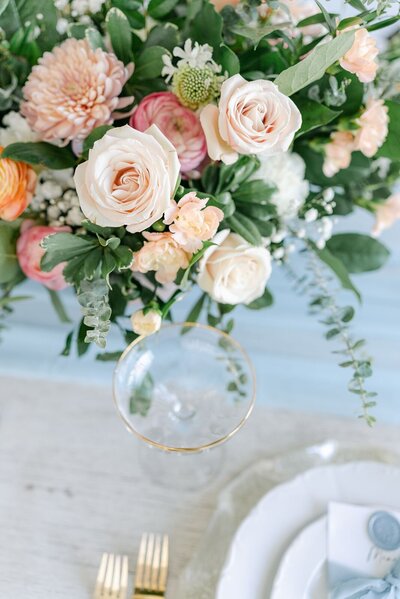 pink roses, pink, orange, green, fresh florals, gold silverware, table setting, light blue
