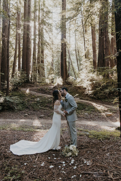 bride and groom first kiss during elopement in California in the redwoods of Big Sur