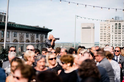 behind the scenes photo of wedding photographer on rooftop