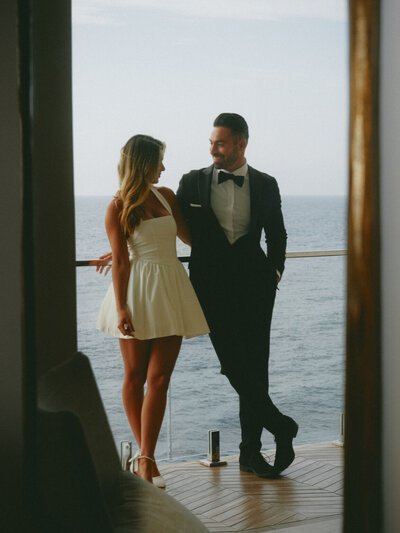 Man holding face in hand laughing at wedding reception in Southern California