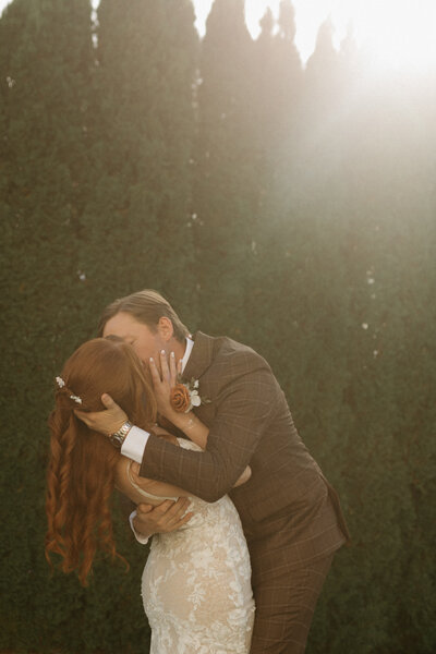 “Bride and groom holding hands in mountain field.”
