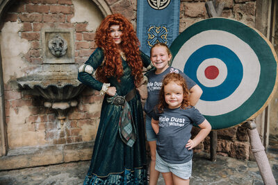 Two girls pose with Merida at Disney World