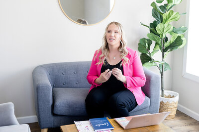Becca sitting on a sofa talking to a client