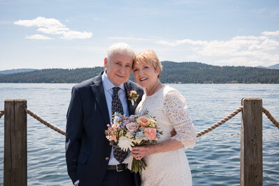 Bride and Groom facing the camera on the Docks of Lake Coeur d"Alene